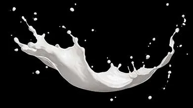 A splash of white milk in mid-air against a black background.