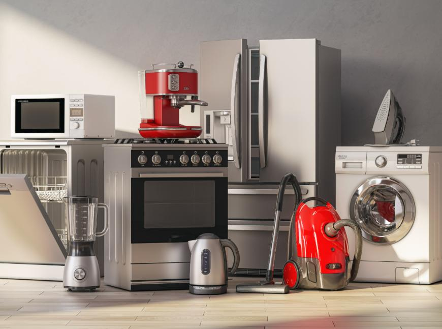 A group of home appliances: a stainless steel refrigerator and oven, red espresso machine, silver kettle, red vacuum cleaner, white washing machine, and iron.